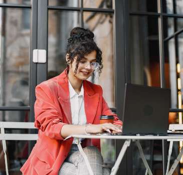 indian woman working laptop street cafe wearing stylish smart clothes jacket glasses